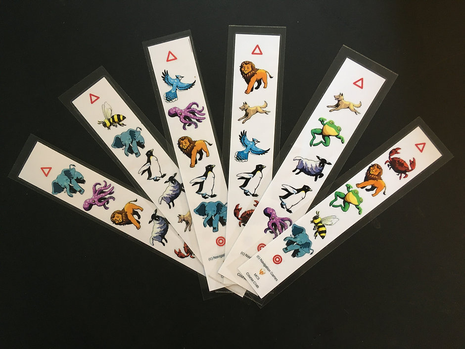Seven laminated clue sheet strips fanned out, each showing a start triangle, a sequence of animal pictures, and a finish circle